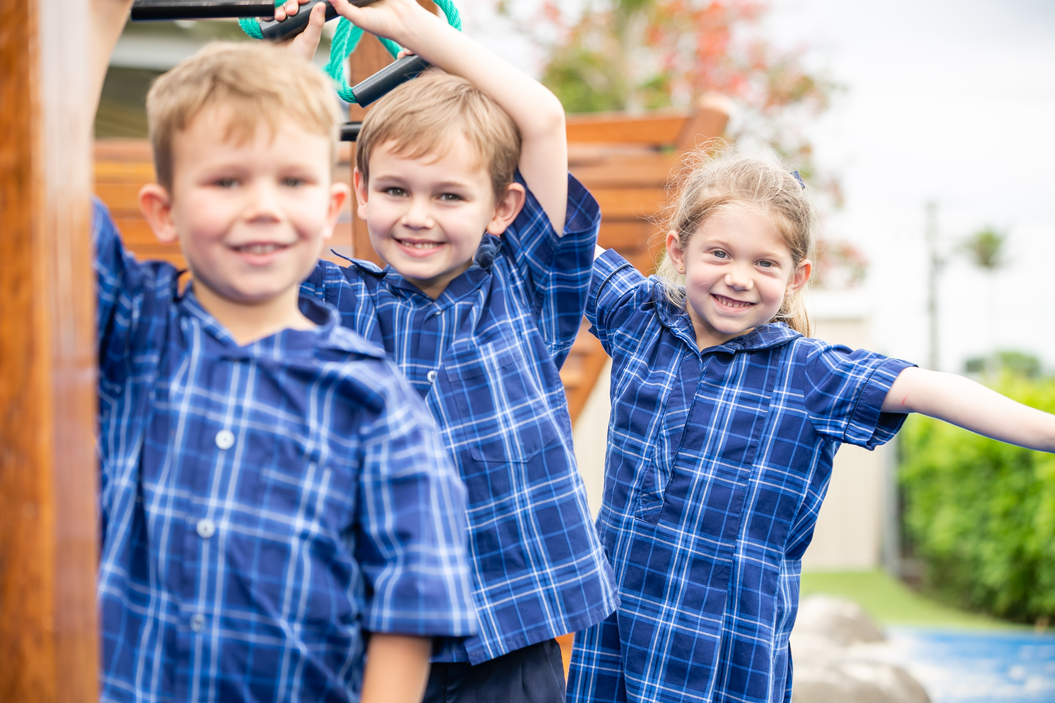 Three primary aged students on the playground.
